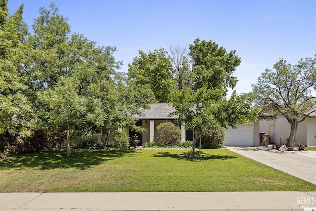 808 La Puente Dr, Bakersfield, CA 93309 - view of property hidden behind natural elements with driveway, a front yard, and a garage