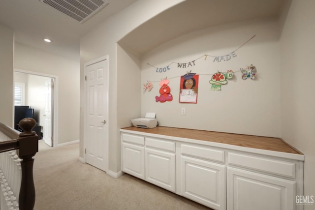 hall with light colored carpet, visible vents, baseboards, and recessed lighting