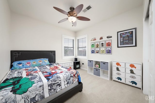 carpeted bedroom with ceiling fan and visible vents