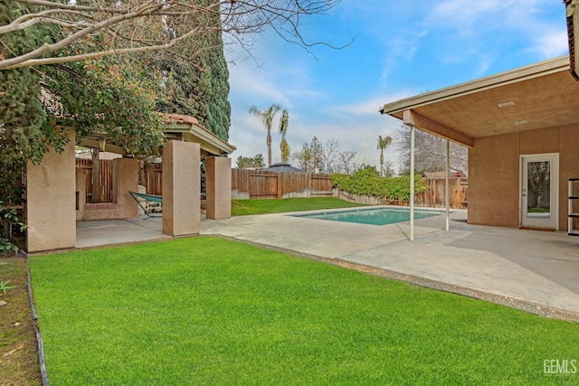 view of yard with a fenced in pool, a fenced backyard, and a patio