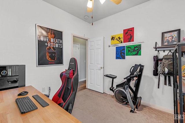 office space featuring carpet floors, ceiling fan, and baseboards