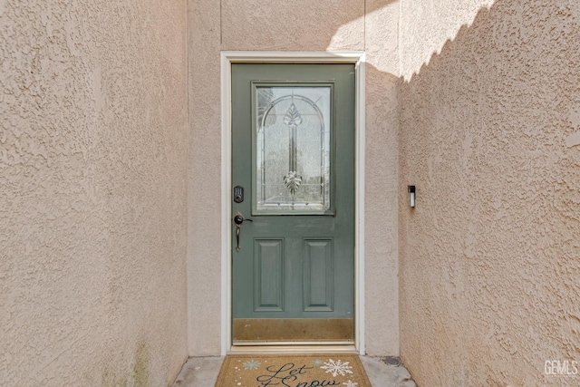 entrance to property with stucco siding