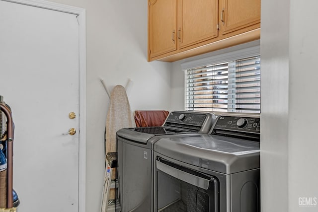 laundry room with cabinet space and washing machine and dryer