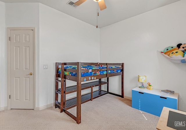 carpeted bedroom with baseboards, visible vents, and a ceiling fan