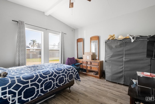 bedroom featuring vaulted ceiling with beams, ceiling fan, and hardwood / wood-style floors