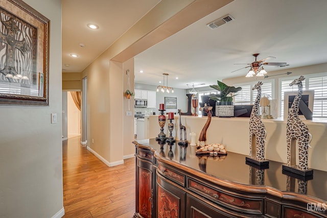 corridor with light hardwood / wood-style floors