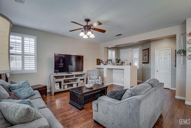 living room featuring dark hardwood / wood-style floors and ceiling fan