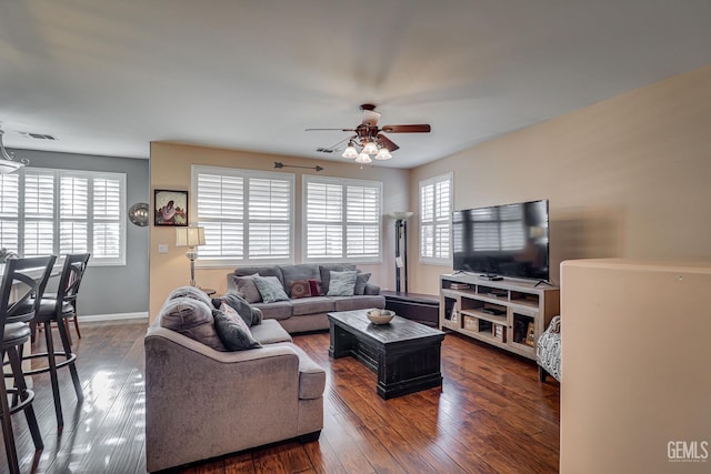 living room featuring dark wood-type flooring and ceiling fan