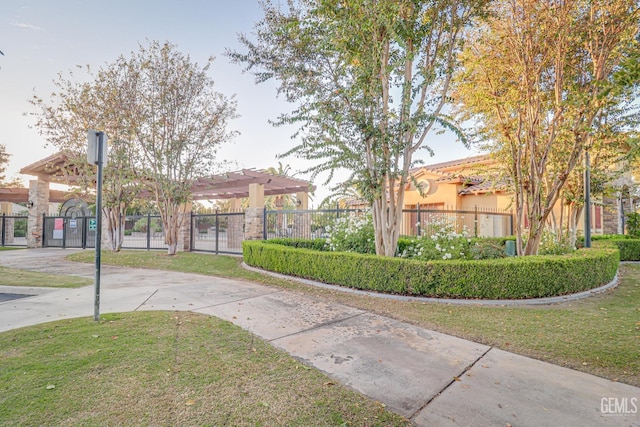 exterior space featuring a front lawn, fence, and stucco siding