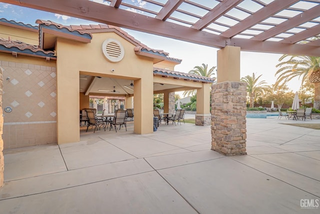 view of patio / terrace featuring outdoor dining space, an outdoor pool, and a pergola