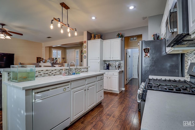 kitchen featuring white cabinets, stove, backsplash, and white dishwasher