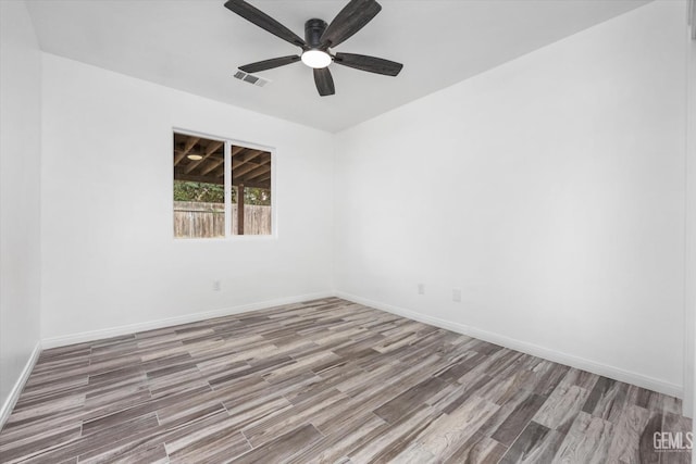 spare room with hardwood / wood-style floors and ceiling fan