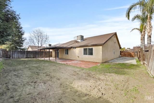 back of property with a patio area and a lawn