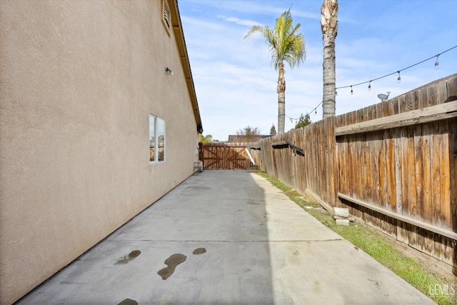 view of property exterior with a patio area