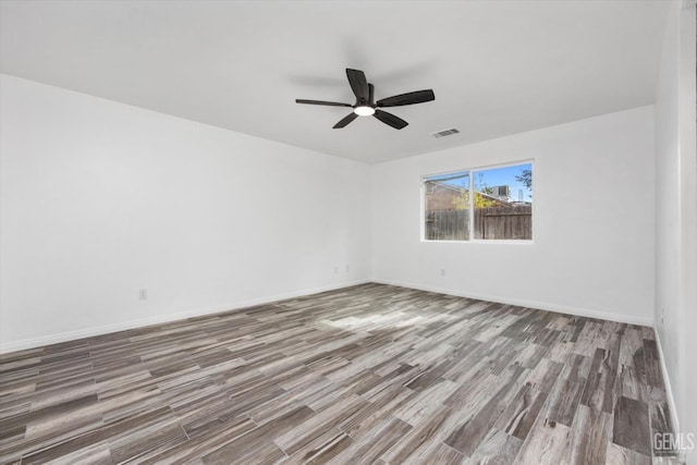 empty room featuring wood-type flooring and ceiling fan