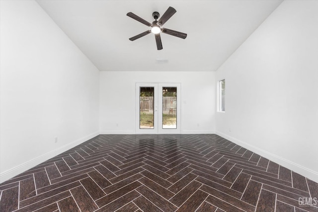 unfurnished room featuring parquet floors, ceiling fan, and french doors