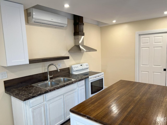 kitchen with white cabinets, a wall mounted air conditioner, white electric range, wall chimney range hood, and a sink