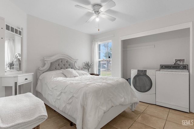 bedroom with light tile patterned floors, ceiling fan, and washer and dryer