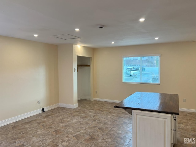 interior space with attic access, baseboards, and recessed lighting