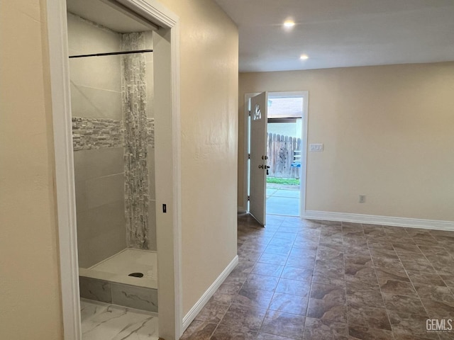 bathroom featuring recessed lighting, a shower stall, and baseboards