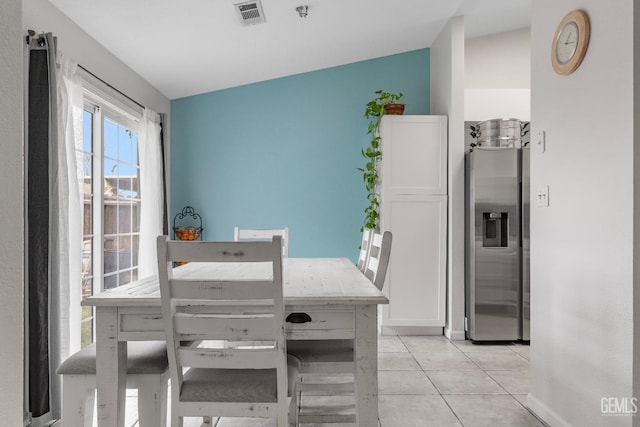 dining space featuring visible vents and light tile patterned floors