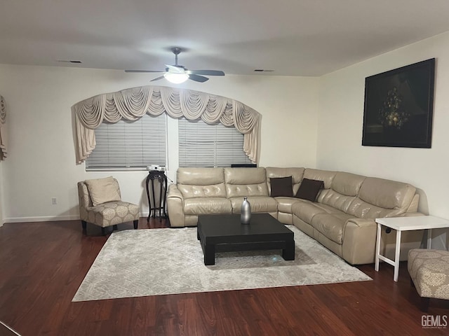 living room featuring ceiling fan and dark hardwood / wood-style flooring