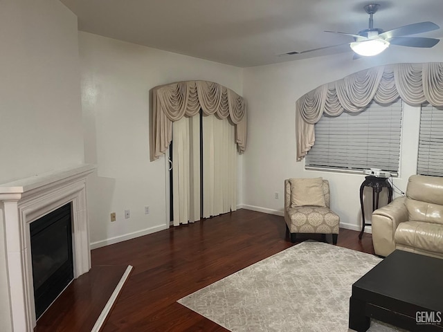 living room with dark wood-type flooring and ceiling fan