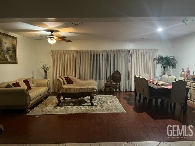 living room featuring ceiling fan and wood-type flooring