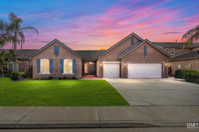 view of front facade featuring a garage and a lawn