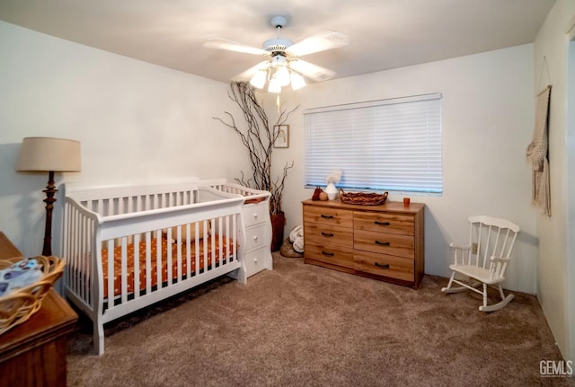 carpeted bedroom with a nursery area and ceiling fan