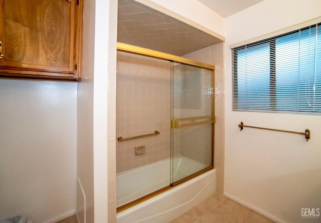 bathroom with tile patterned flooring and combined bath / shower with glass door