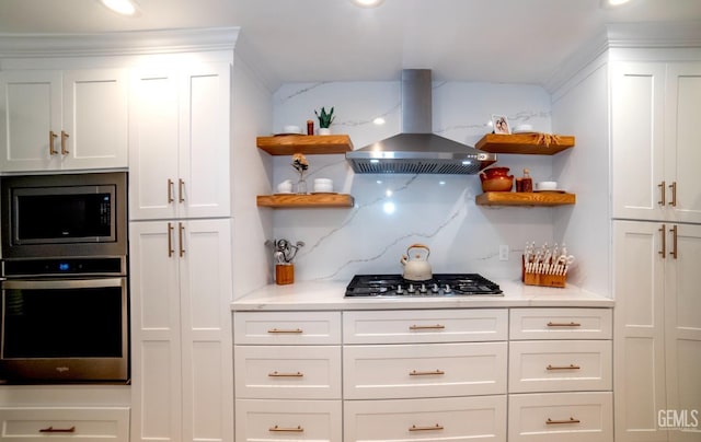 kitchen featuring appliances with stainless steel finishes, white cabinetry, and extractor fan