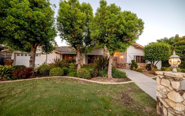 view of front of house with a garage and a front lawn