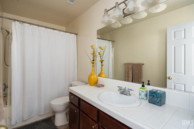 full bathroom with shower / bath combination with curtain, vanity, and toilet