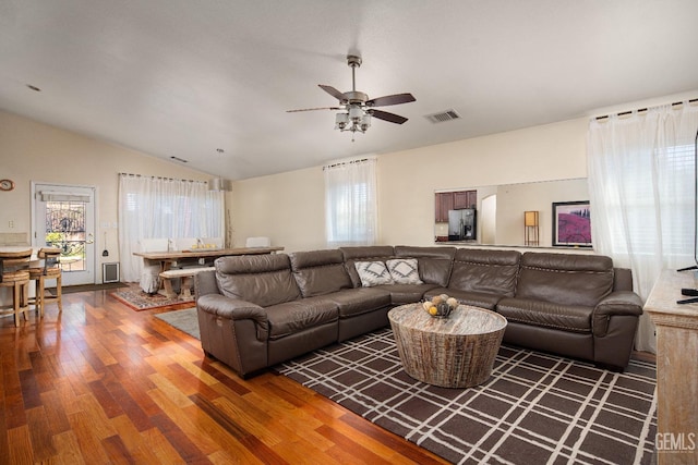 living room with lofted ceiling, dark wood-type flooring, and ceiling fan