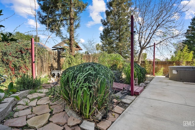 view of yard featuring a patio area and a hot tub