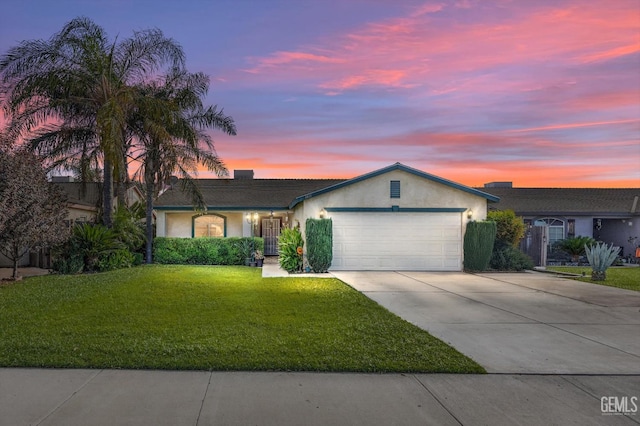 ranch-style house featuring a yard and a garage