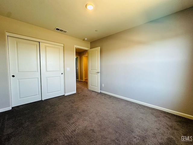 5910 Bogart Dr, Bakersfield, CA 93313 - unfurnished bedroom featuring dark colored carpet and a closet