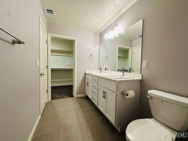 5910 Bogart Dr, Bakersfield, CA 93313 - bathroom featuring double vanity, a spacious closet, and tile patterned floors