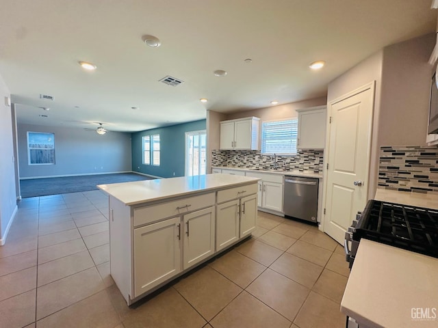 5910 Bogart Dr, Bakersfield, CA 93313 - kitchen featuring dishwasher, decorative backsplash, a kitchen island, light tile patterned flooring, and recessed lighting