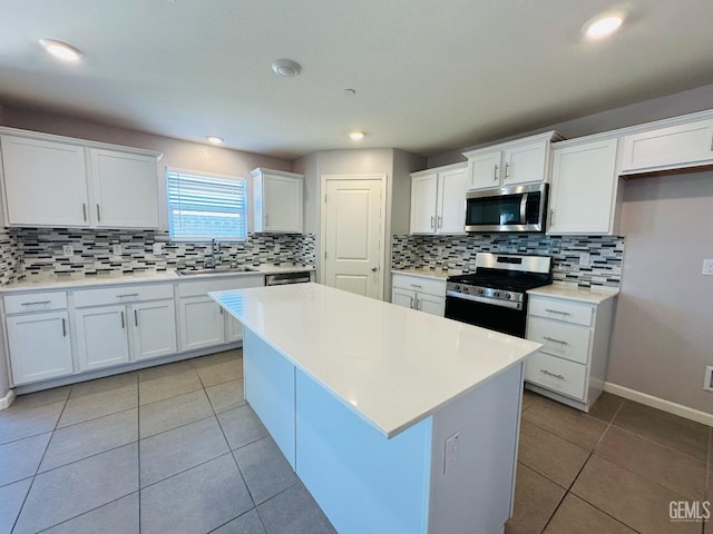 5910 Bogart Dr, Bakersfield, CA 93313 - kitchen with stainless steel appliances, light tile patterned floors, white cabinetry, decorative backsplash, and recessed lighting