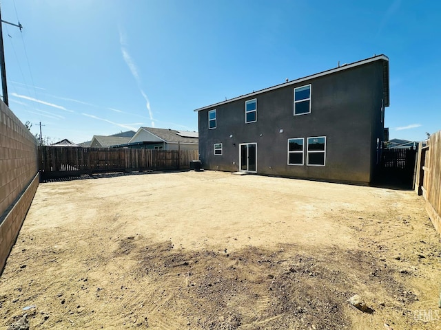 5910 Bogart Dr, Bakersfield, CA 93313 - rear view of property with stucco siding and a fenced backyard