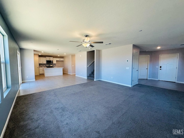 5910 Bogart Dr, Bakersfield, CA 93313 - unfurnished living room featuring light carpet, stairway, a ceiling fan, recessed lighting, and light tile patterned floors