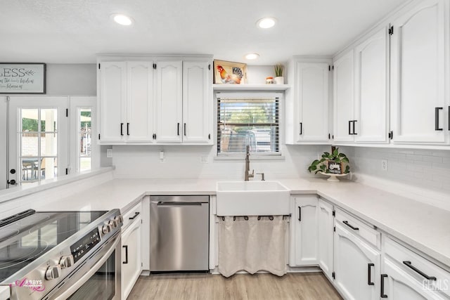 11265 Poulsen Way, Bakersfield, CA 93312 - kitchen featuring stainless steel appliances, white cabinetry, healthy amount of natural light, and recessed lighting