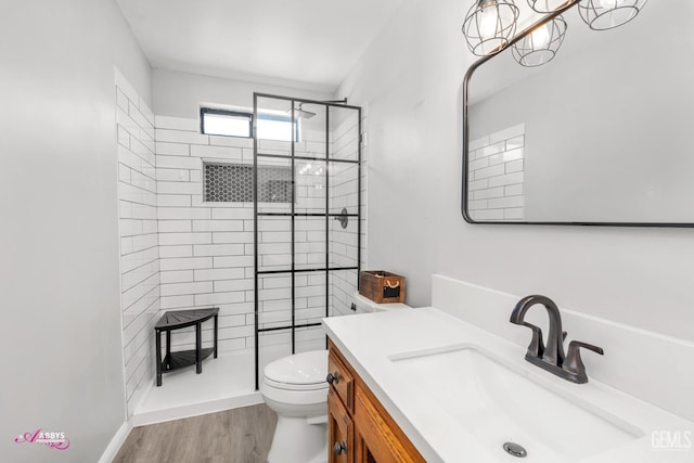 11265 Poulsen Way, Bakersfield, CA 93312 - bathroom featuring tiled shower, vanity, and wood finished floors
