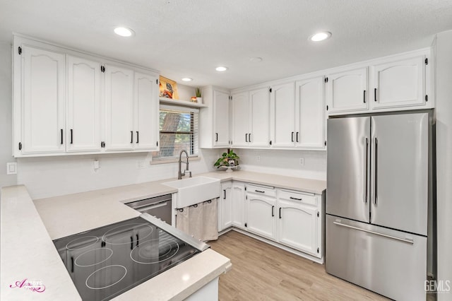 11265 Poulsen Way, Bakersfield, CA 93312 - kitchen with stainless steel appliances, white cabinets, light countertops, light wood-type flooring, and recessed lighting