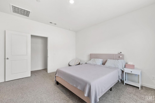 carpeted bedroom featuring visible vents and baseboards