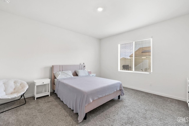 bedroom featuring light carpet and baseboards