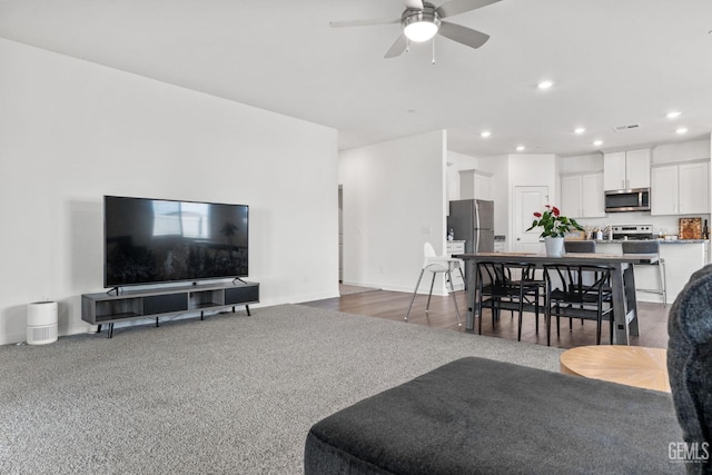 living area featuring visible vents, recessed lighting, a ceiling fan, and carpet floors