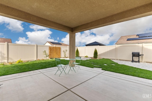 view of patio featuring grilling area, outdoor dining space, and a fenced backyard